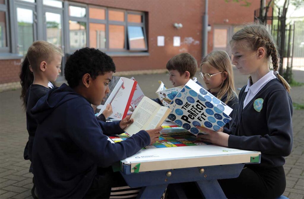 Children sat at a table reading